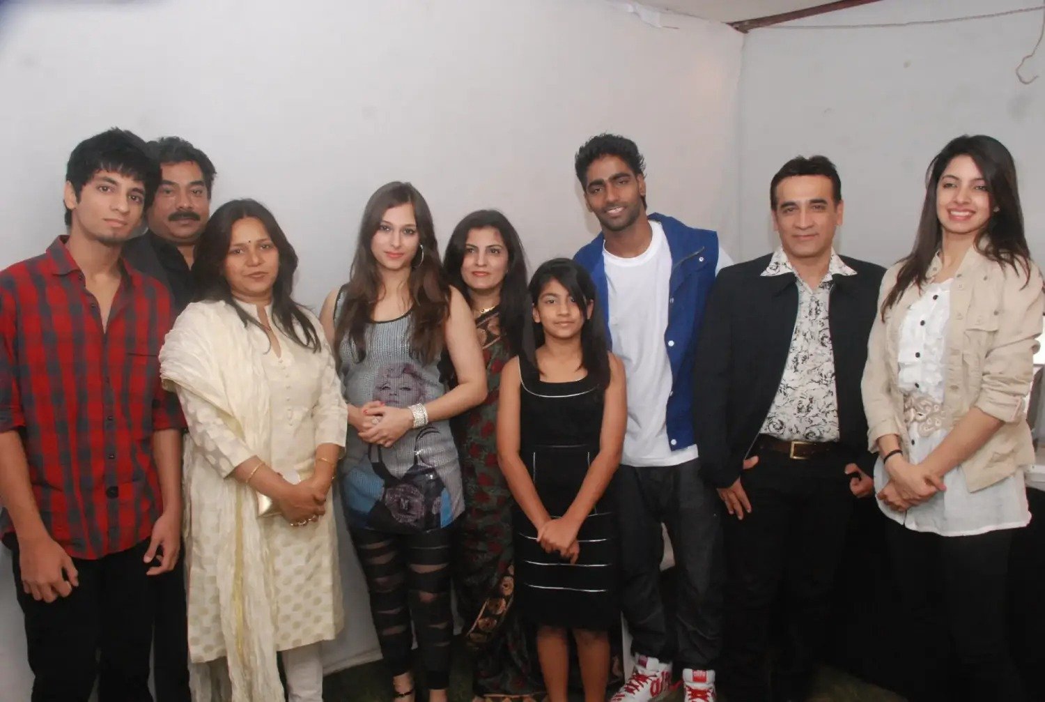 Man and woman speaking on stage at night with blue lighting